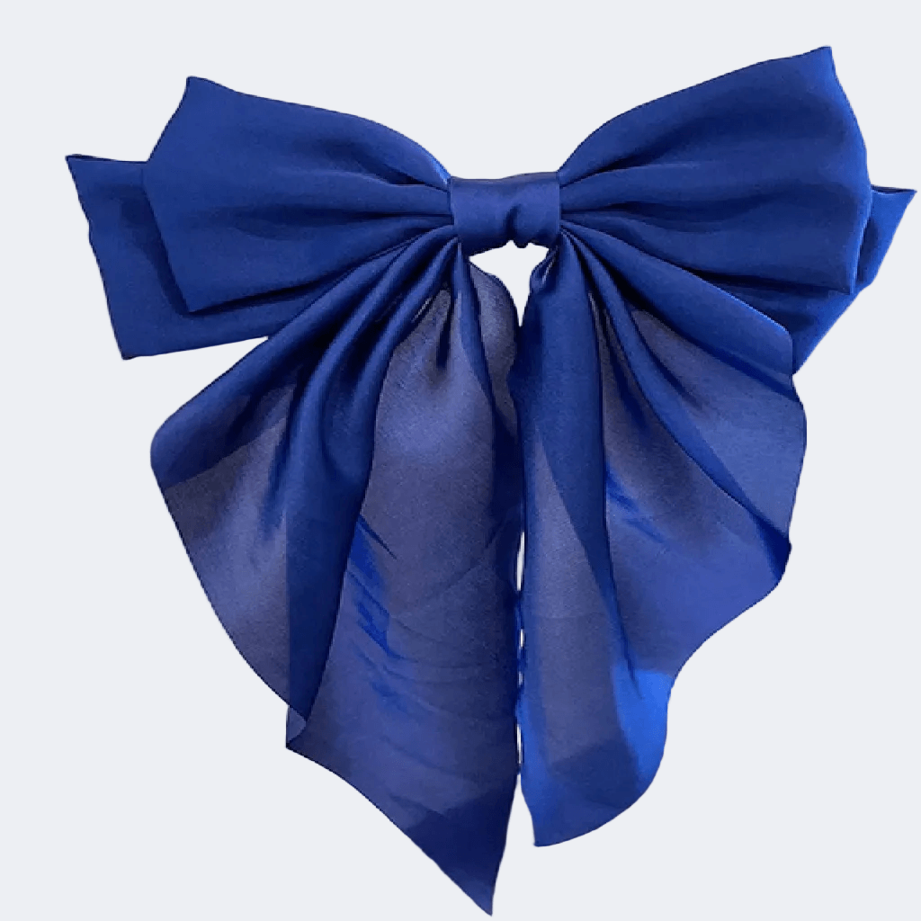 Person with long dark hair wearing a large blue bow in the back on a white background
