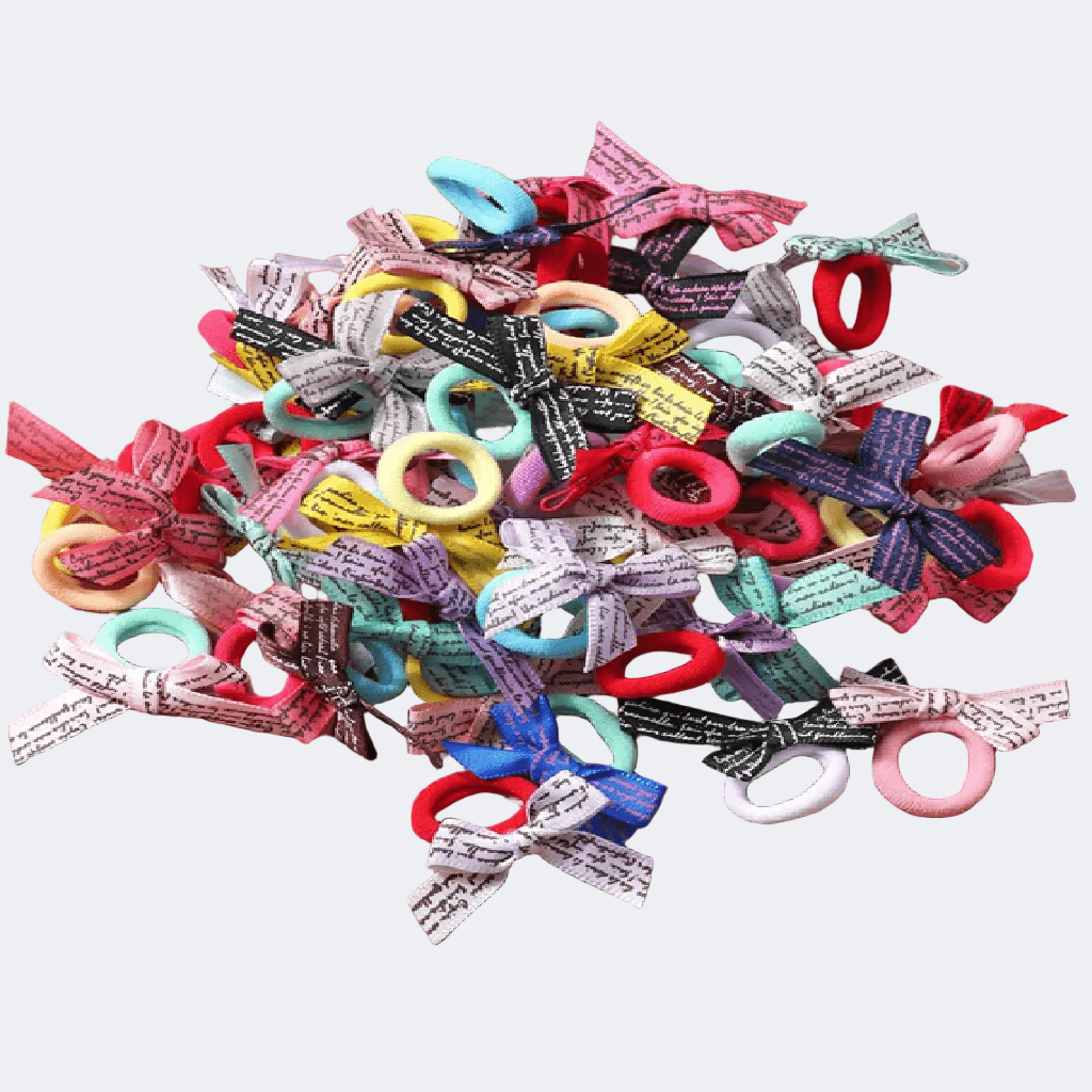 Assorted colorful hair bows with various designs on a light gray background