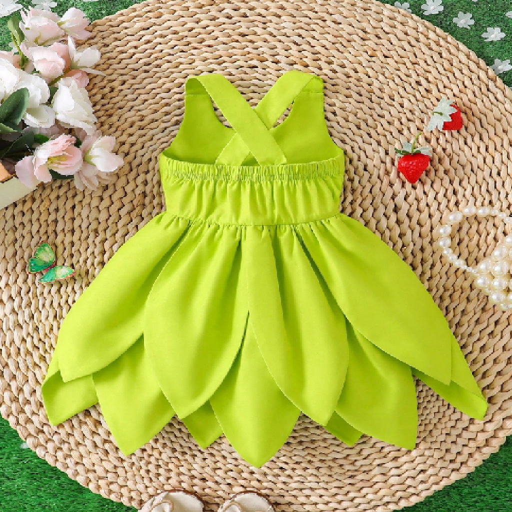 Green dress on a woven mat with flowers and strawberries in the background