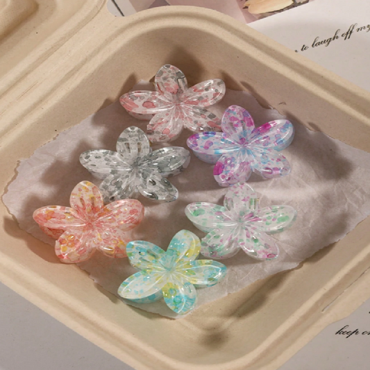 Colorful butterfly-shaped hair clips on a beige tray