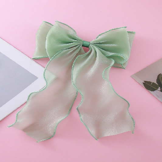 Green bow on a pink background
