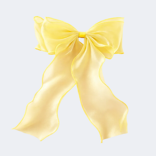Yellow satin bow on a white background
