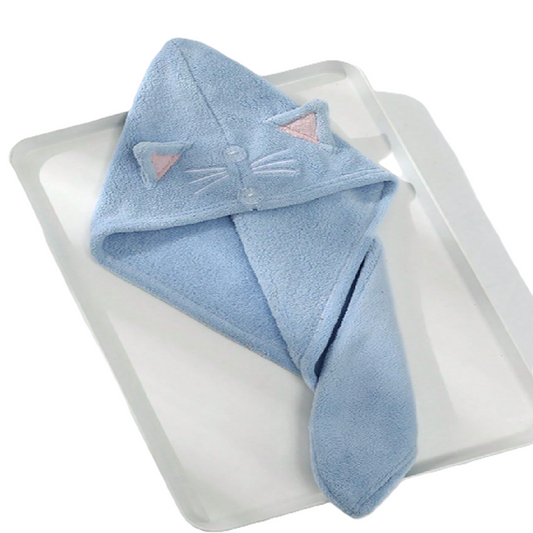 Blue hooded towel with cat ears and face on a white surface