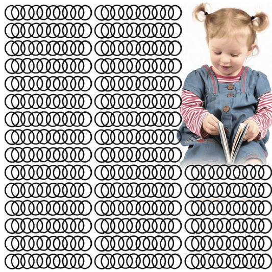 Child reading a book surrounded by multiple black hair ties on a white background