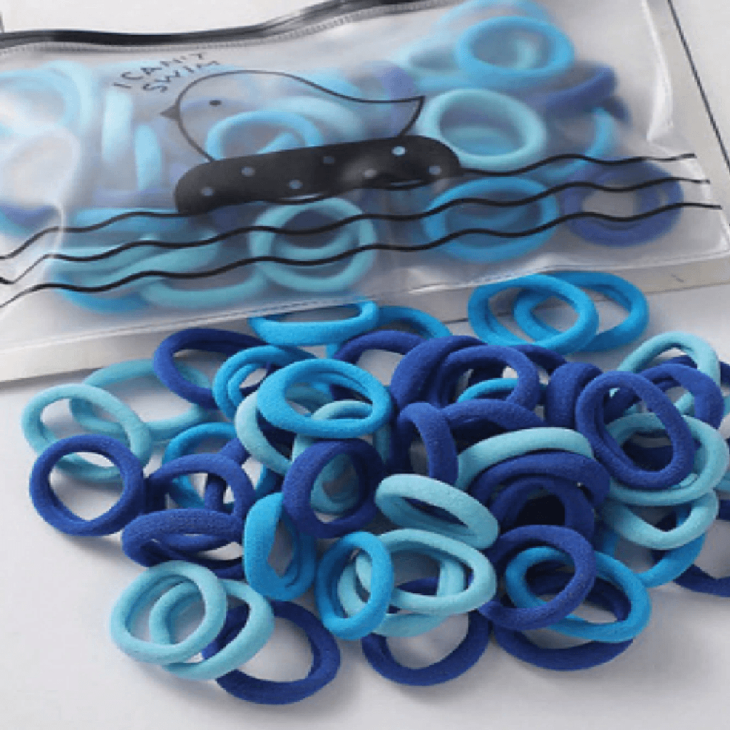 Blue and purple hair ties with a clear plastic bag in the background