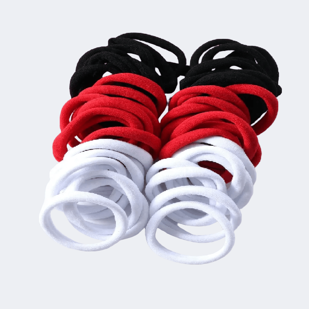 Set of black, red, and white hair ties on a white background