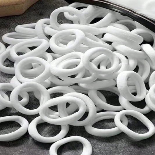White rubber O-rings on a gray surface