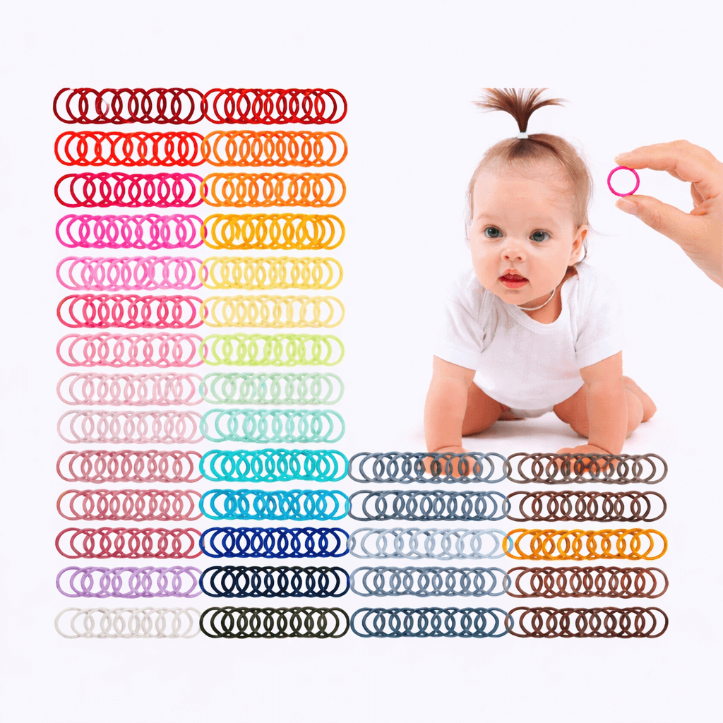 Baby sitting next to a row of colorful rubber bands on a white background