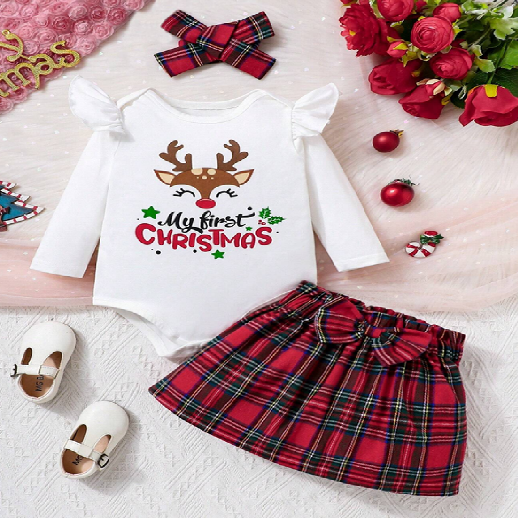 Christmas-themed baby outfit with reindeer design and plaid skirt on a light background