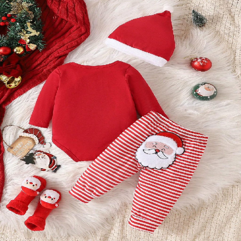 Baby Christmas outfit with red onesie, striped pants, and Santa hat on a fluffy white surface.