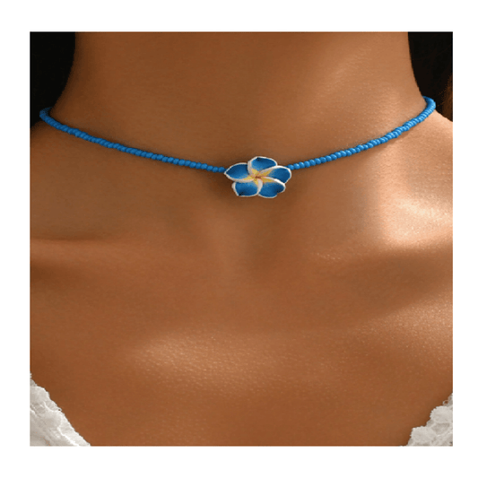 Blue necklace with a floral pendant on a person's neck