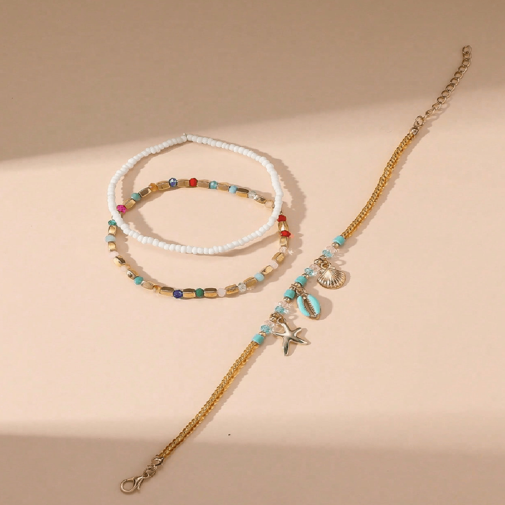 Three necklaces with beads and charms on a beige background