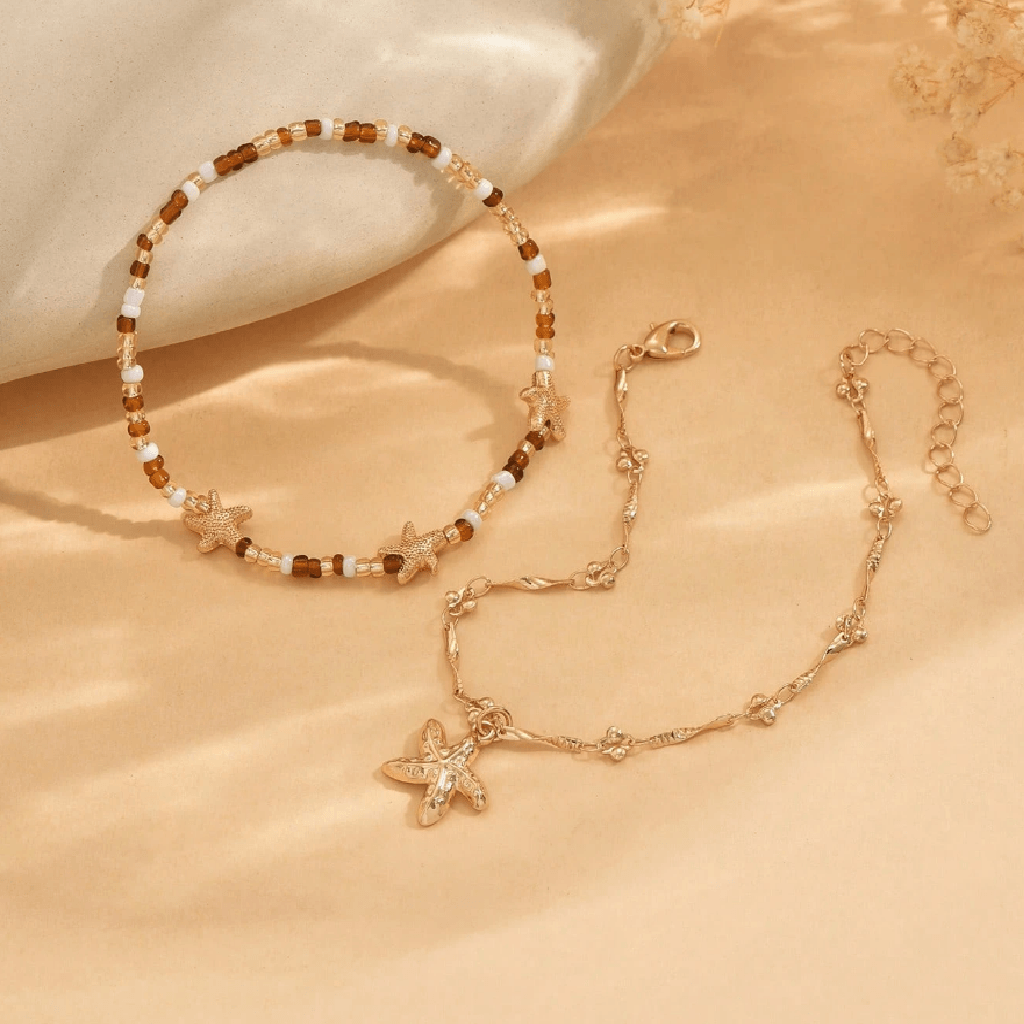 Starfish-themed necklace and bracelet set on a beige surface