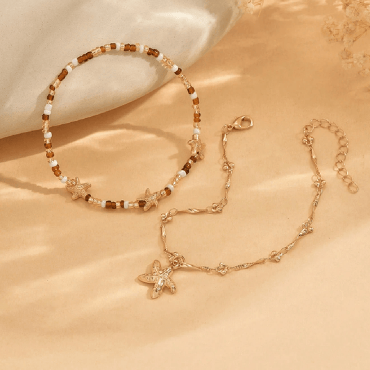 Starfish-themed necklace and bracelet set on a beige surface