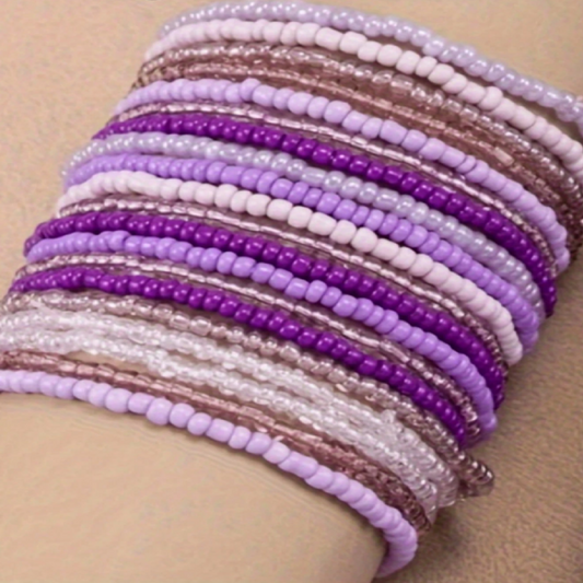 Stack of beaded bracelets in purple, pink, and brown