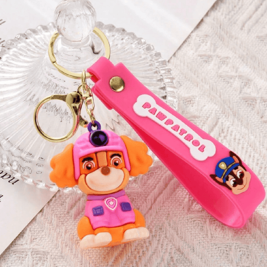 Pink keychain with a character from Paw Patrol on a textured surface
