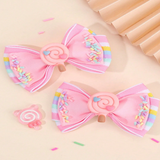 Two pink hair bows with colorful sprinkles