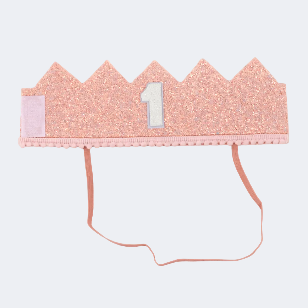 Pink glittery crown with a number 1 on a white background