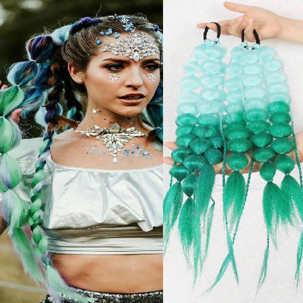 Woman with styled hair and face, holding green hair extensions.