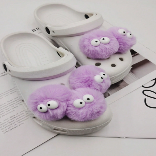 White slippers with purple fuzzy monsters
