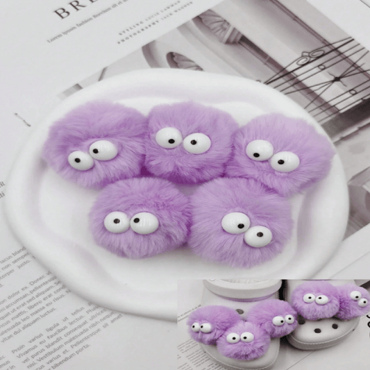 Purple fuzzy monsters on a white plate with a newspaper background