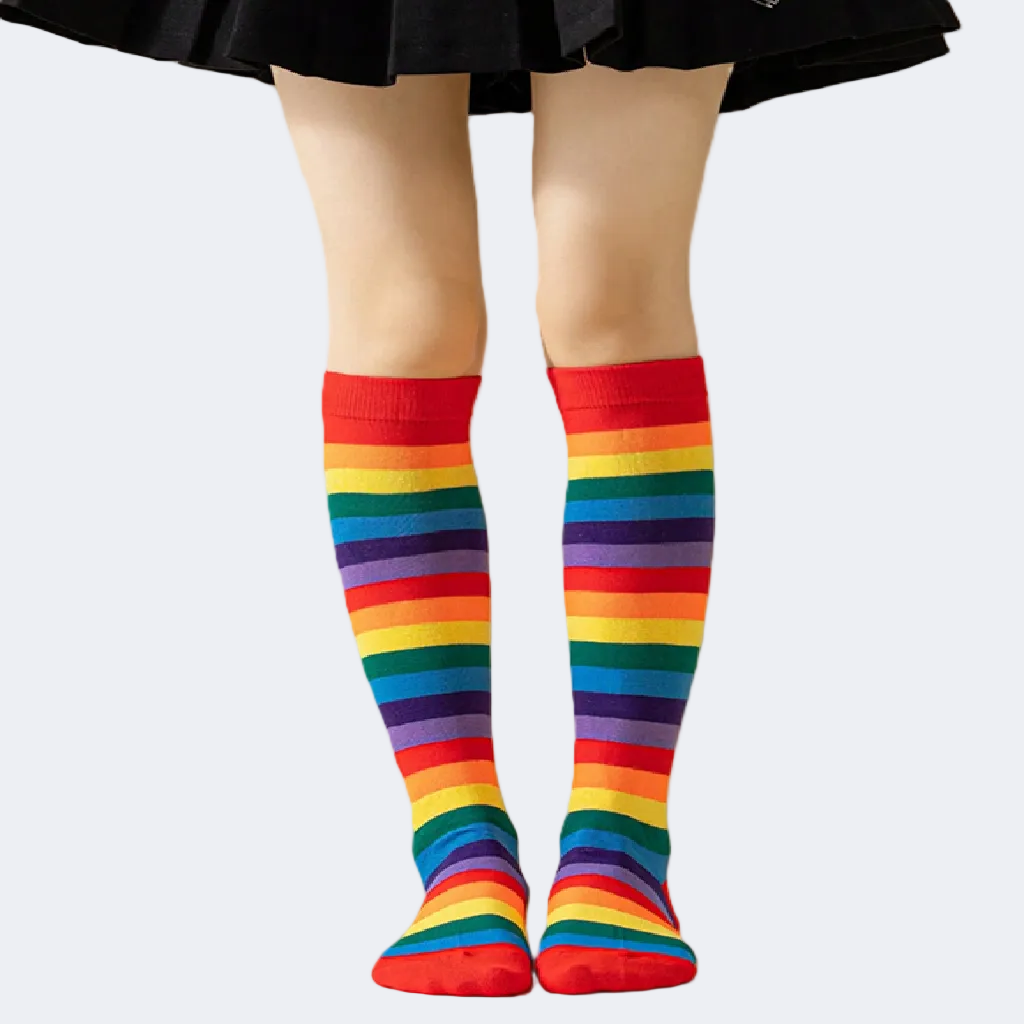 Rainbow striped knee-high socks worn with a black skirt