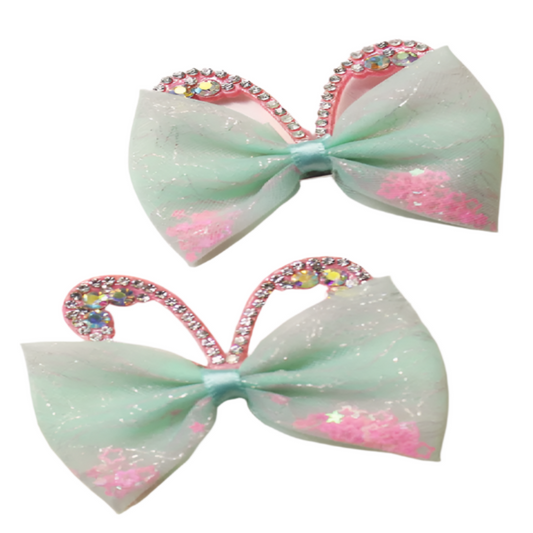 Two decorative bows with rhinestone hearts