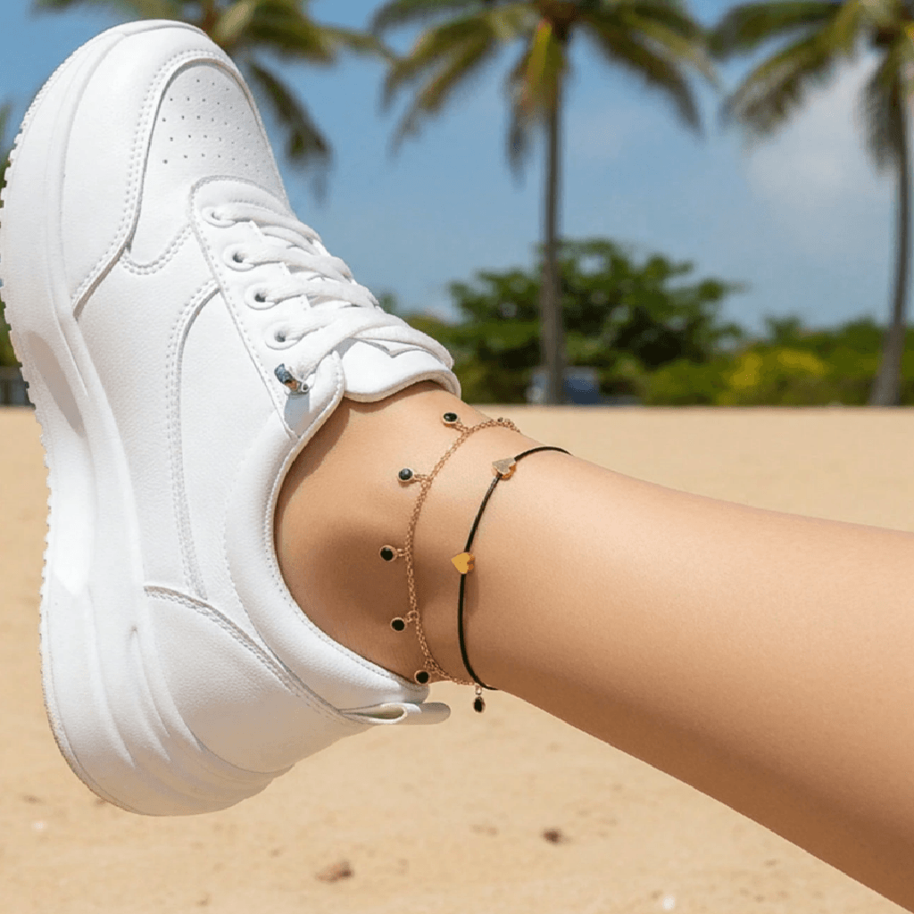 White sneaker on a foot with palm trees in the background