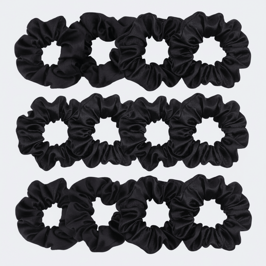 Set of black scrunchies on a light gray background