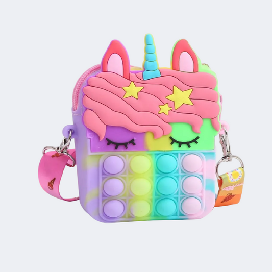 Colorful unicorn-themed pop-it fidget toy with a keychain on a white surface.