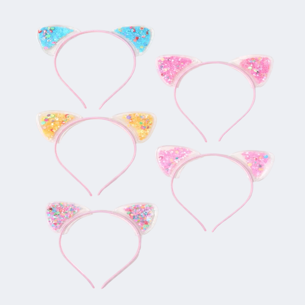 Set of four pink cat ear headbands with colorful decorations on a white background