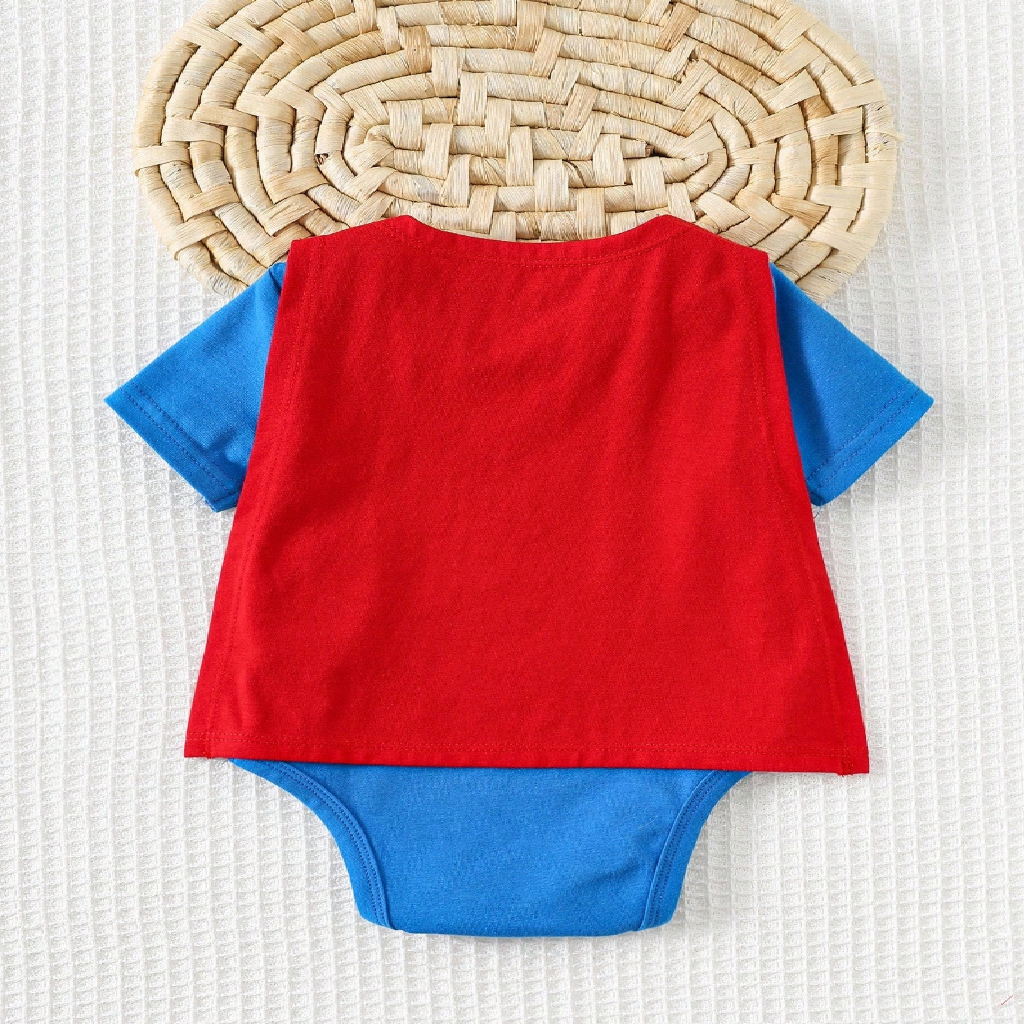 Red and blue baby romper on a textured surface