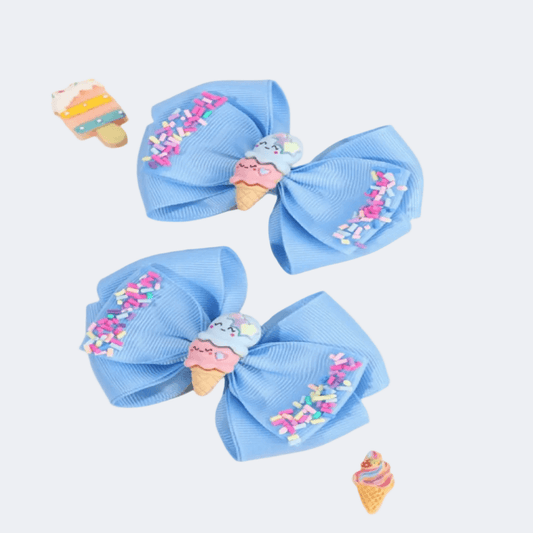 Three blue hair bows with ice cream cone decorations on a white background