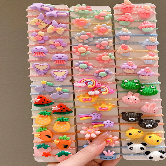 Collection of colorful hair clips held by a hand against a brown background