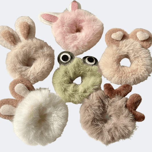 Set of plush animal-shaped hair ties on a light gray background