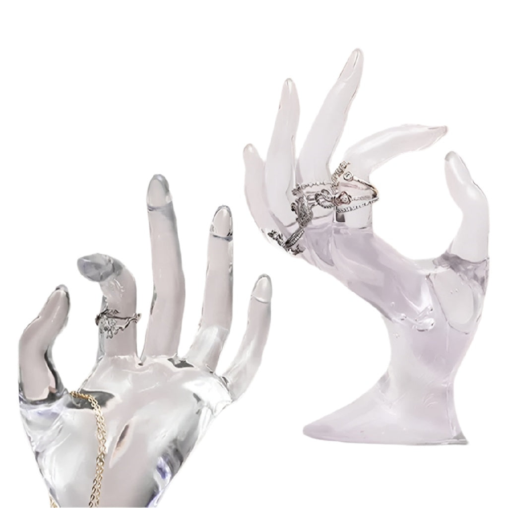 Clear acrylic hand-shaped jewelry display with rings
