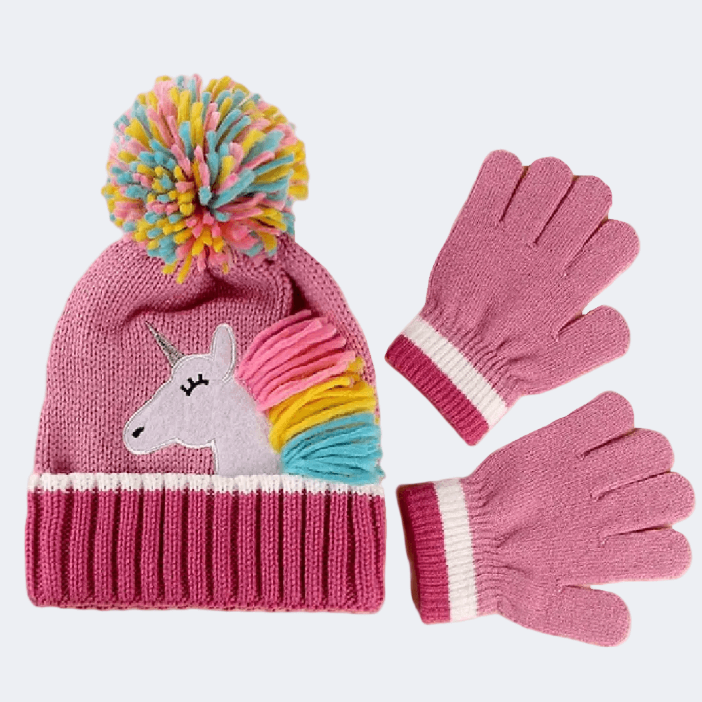 Pink knit hat with unicorn design and colorful pom-pom, paired with matching gloves on a white background.
