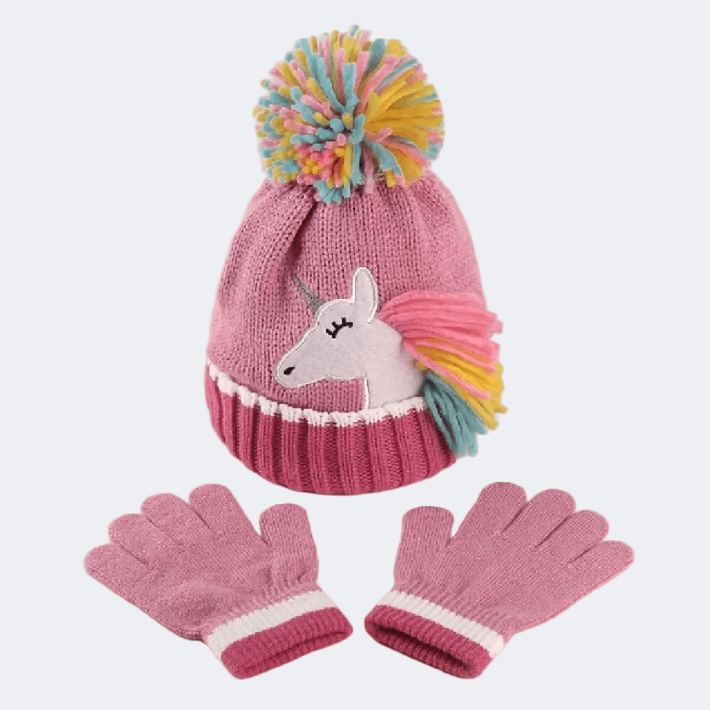Pink knit hat with unicorn design and colorful pom-pom, paired with matching gloves on a light gray background.