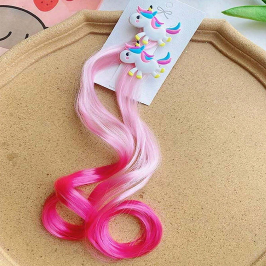 Pink and red hair extensions with a unicorn-themed clip 