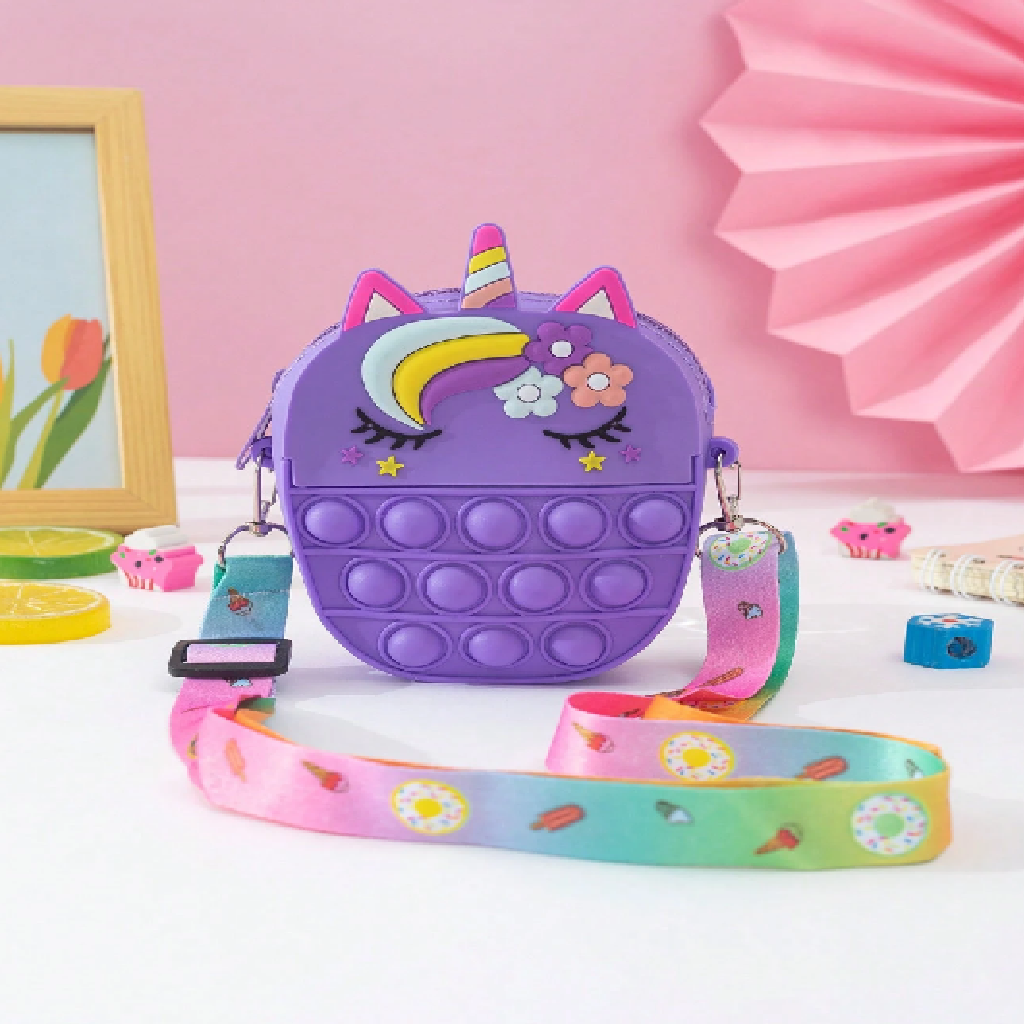 Purple unicorn-shaped pop-it bag with a colorful strap on a pink background