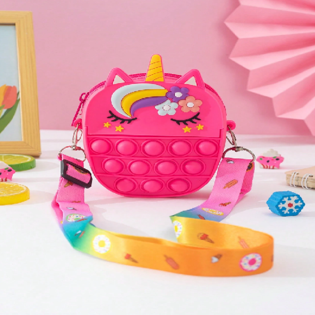 Pink unicorn-shaped fidget bag with a colorful strap on a pink background