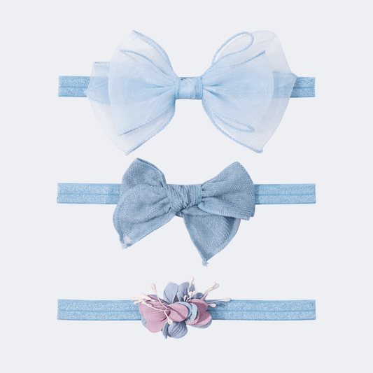 Three light blue hair bows with different designs on a white background