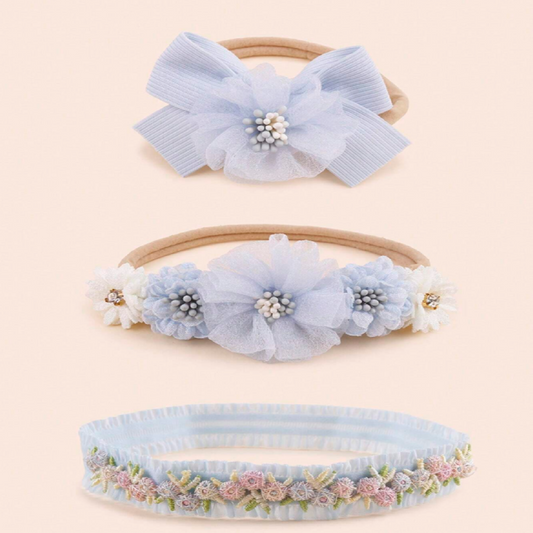 Three decorative headbands with floral and bow designs