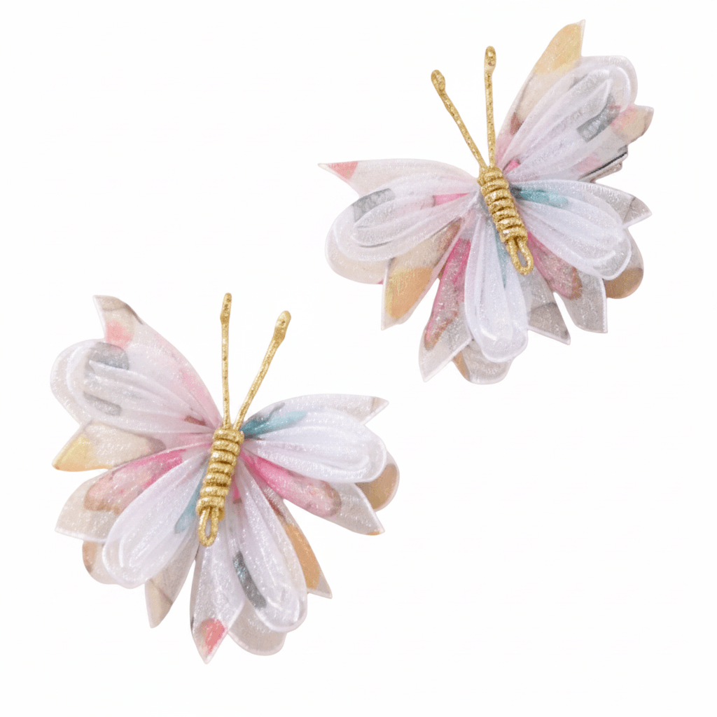 Two butterfly-shaped hair accessories with pastel colors on a white background
