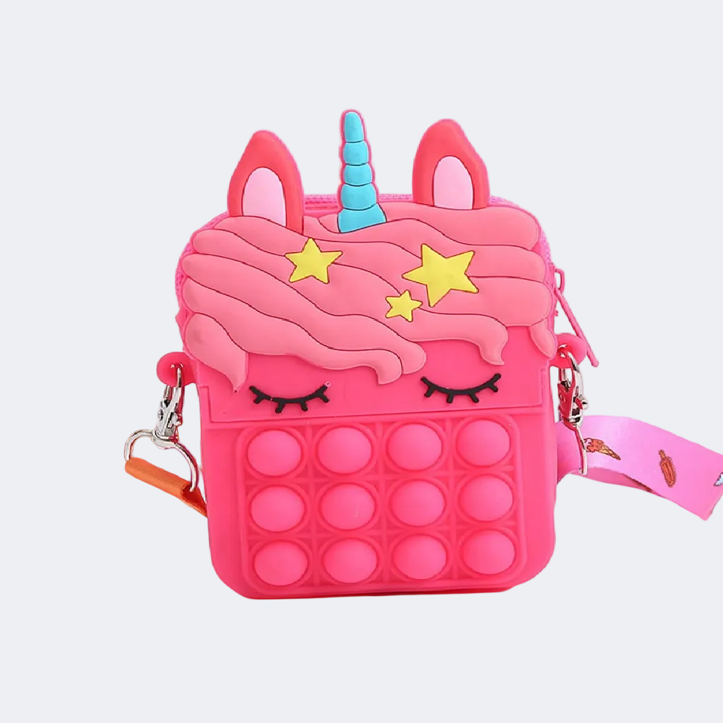 Pink unicorn-shaped pop-it bag on a white surface with a blurred background