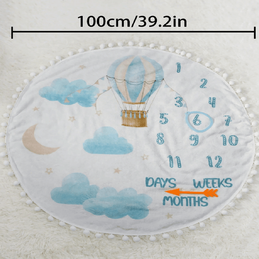 Baby milestone mat with hot air balloon design and measurement text on a white background