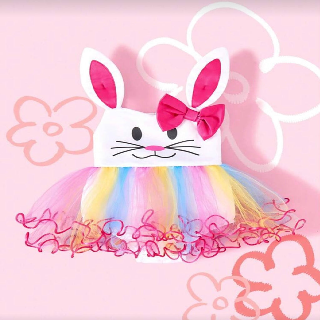 Children's dress with bunny ears and colorful skirt on a pink floral background