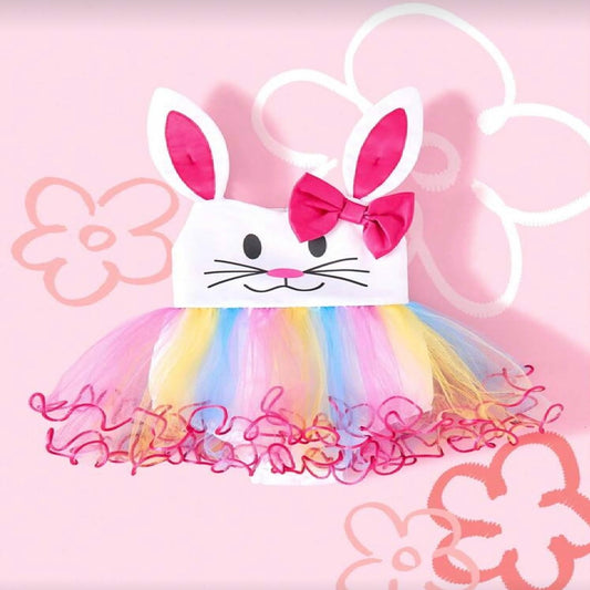 Children's dress with bunny ears and colorful skirt on a pink floral background