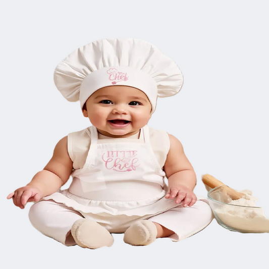 Baby wearing a 'Little Chef' outfit with a chef's hat and apron on a white background