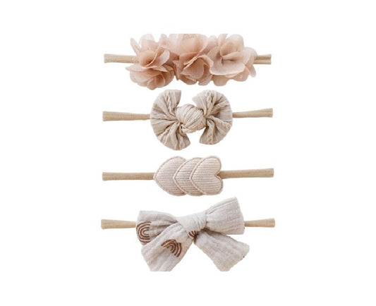 Set of four decorative hair bands with floral and bow designs off white